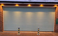 2 Ramco 100's installed infront of a garage with lights above.
